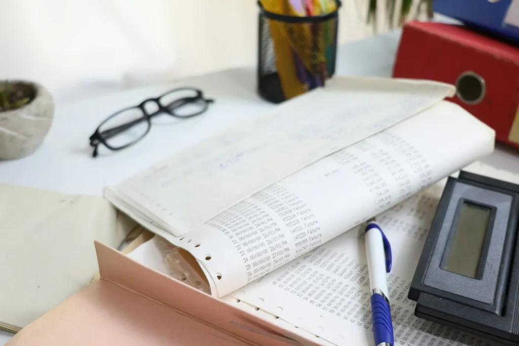 Paperwork, calculator and office supplies on an accountant's desk